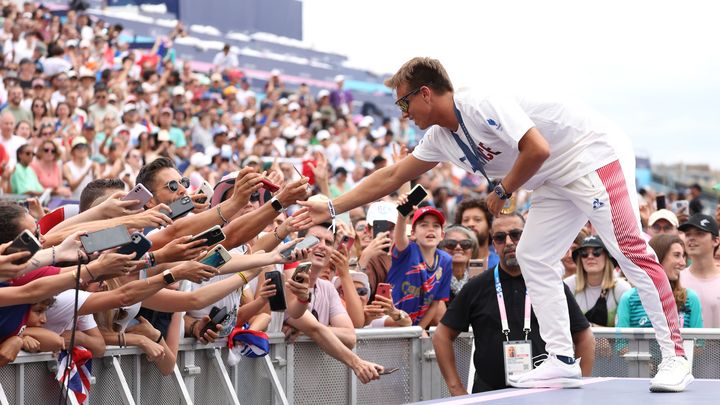 Le surfeur français Kauli Vaast célèbre son titre olympique avec des supporters au Parc des champions, installé au Trocadéro, le 9 août 2024. (PASCAL LE SEGRETAIN / GETTY IMAGES EUROPE)